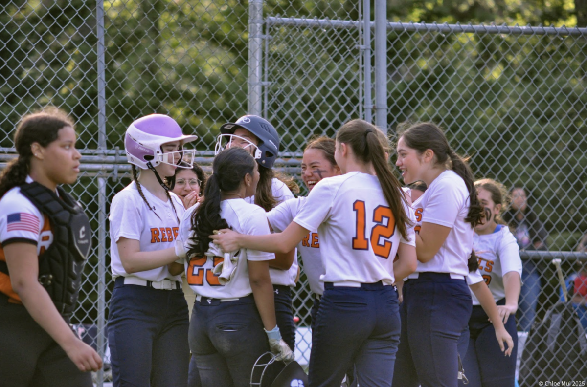 A Home Run Team—The girls congratulate Junior Hannah Joy after hitting a home run. They built an off-the-field bond, attributing to sweet moments like these during games.

